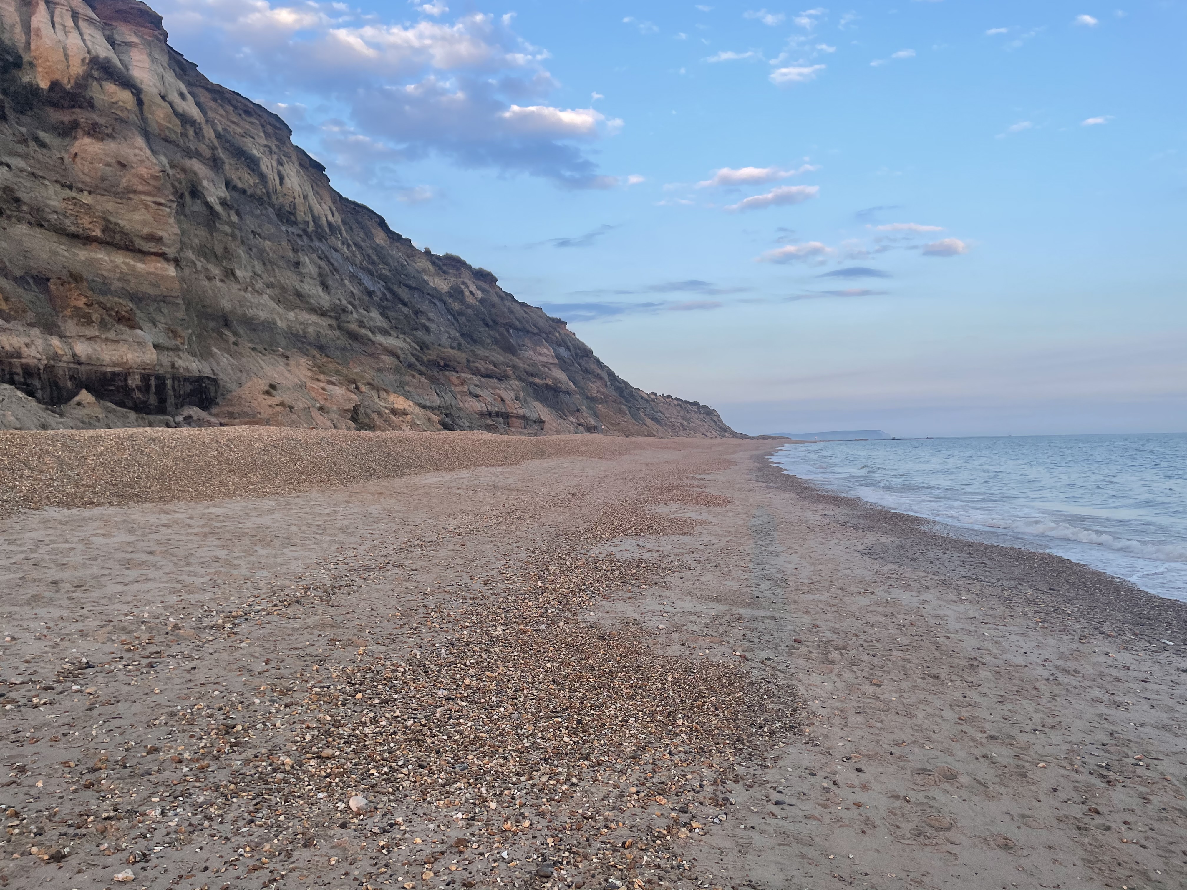 Hengistbury Head beach and sandstone cliffs at sunset